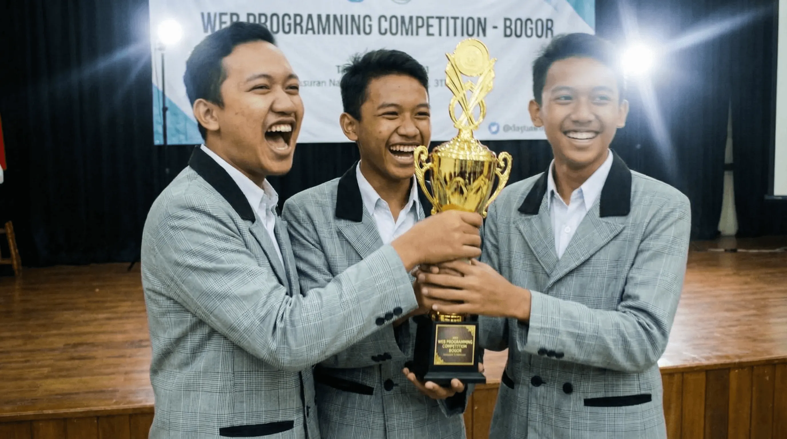 person discussing while standing in front of a large screen in front of people inside dim-lighted room